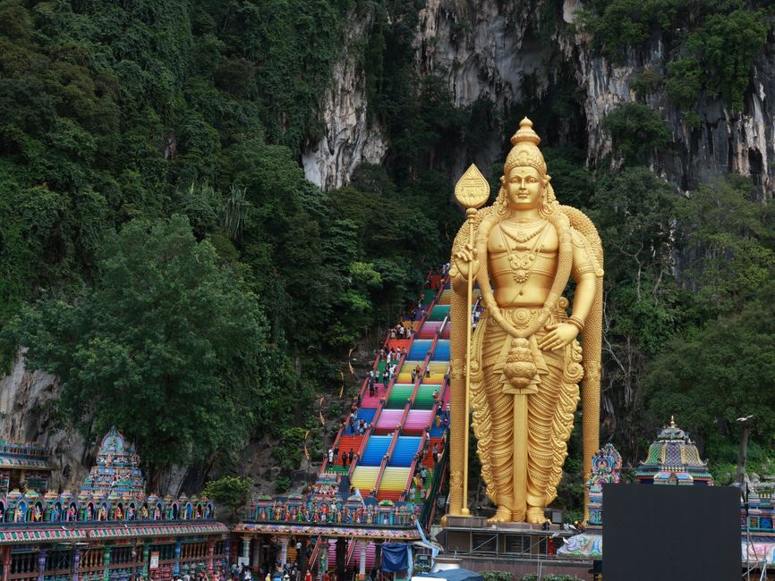 Batu Caves golden gopuram temple staircase illuminated Deepavali decorations night Malaysia