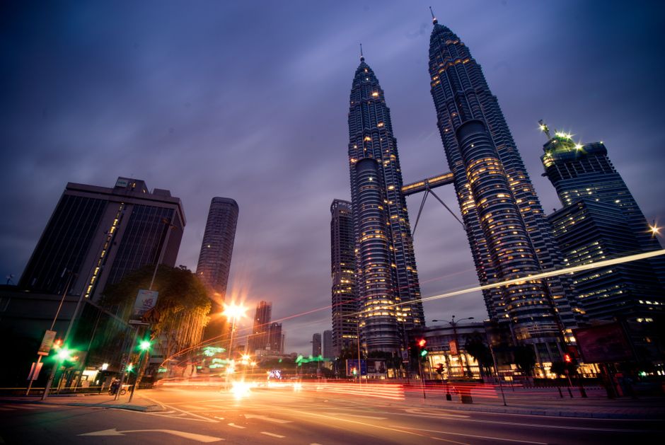 Kuala Lumpur city centre street traffic Malay English road signs KLCC skyline urban Malaysia