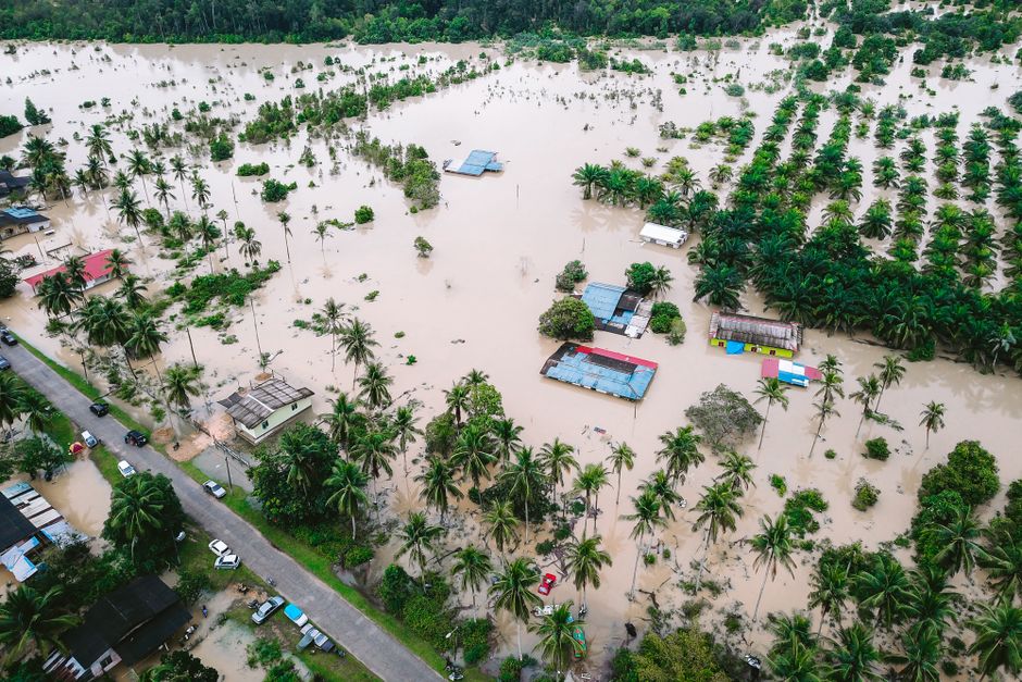 Flooded road in Kelantan Malaysia with cars turning back during northeast monsoon