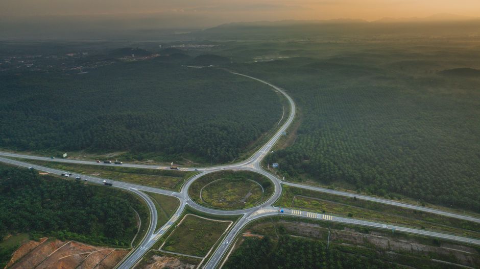 Malaysian highway North-South Expressway open road green hills sunrise