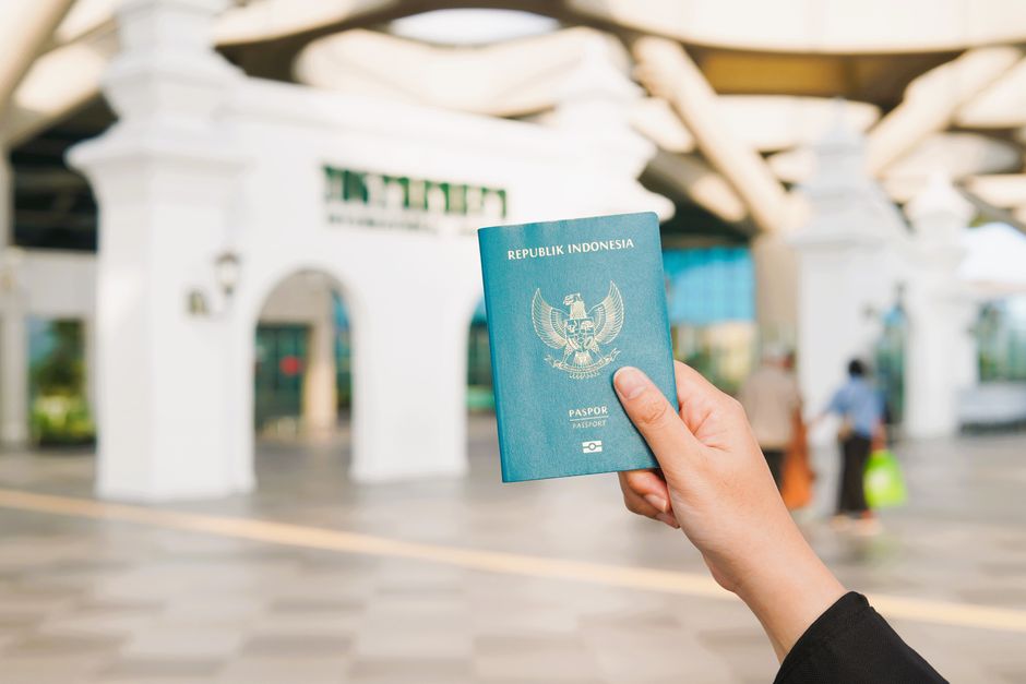 traveller holding driving licence and passport at car rental counter Malaysia airport